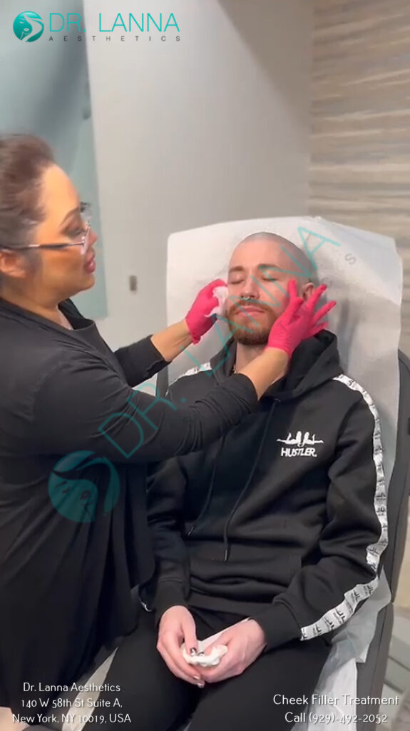 Gloved practitioner injecting cheek filler into a woman's face