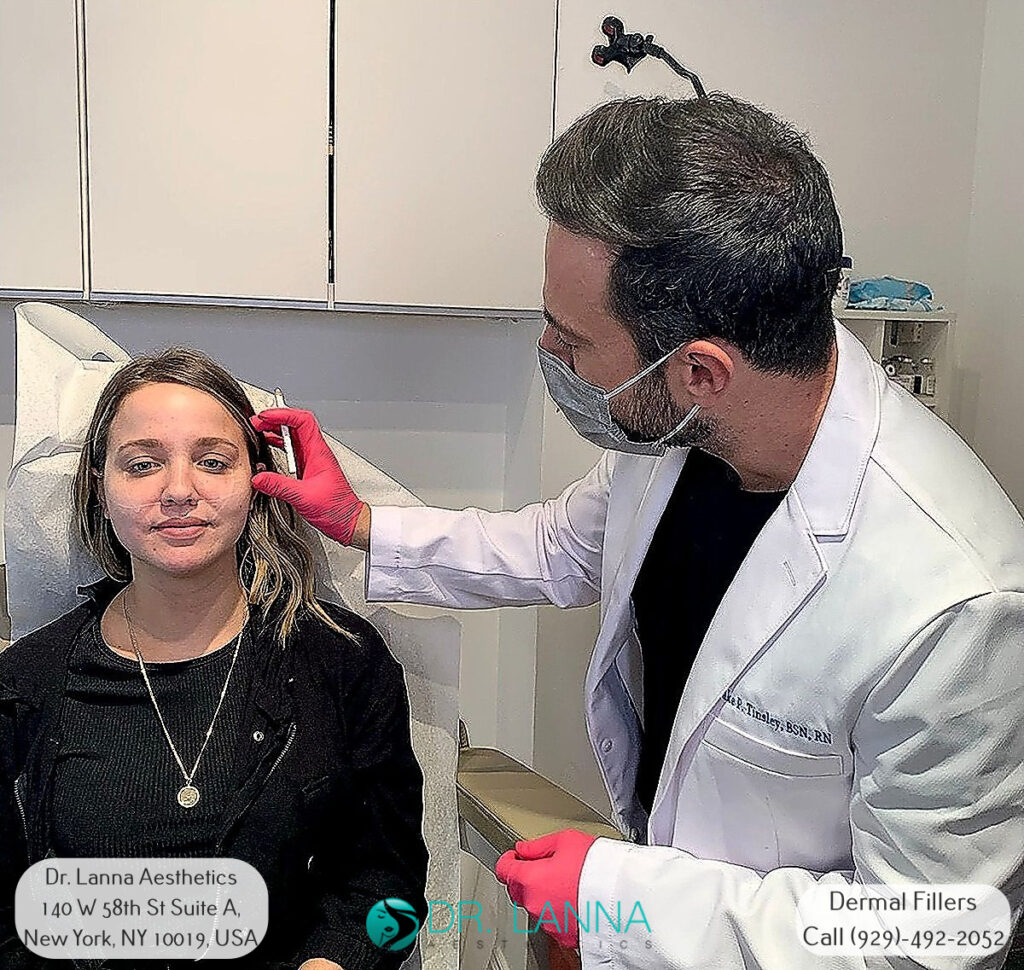 woman undergoes cheek filler treatment inside Dr. Lanna's clinic