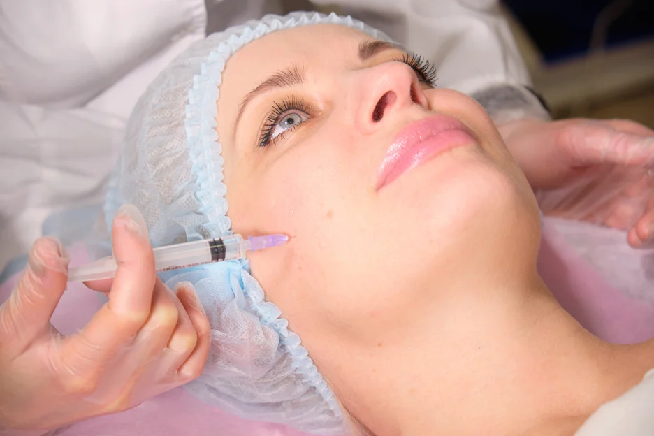 A woman getting cheek filler treatment