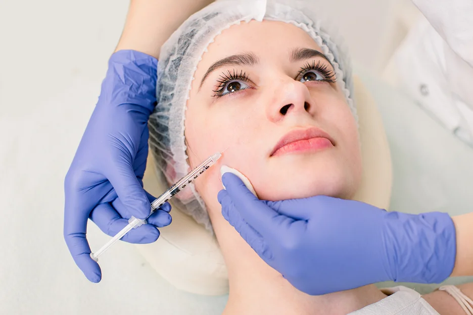 A woman getting cheek filler treatment