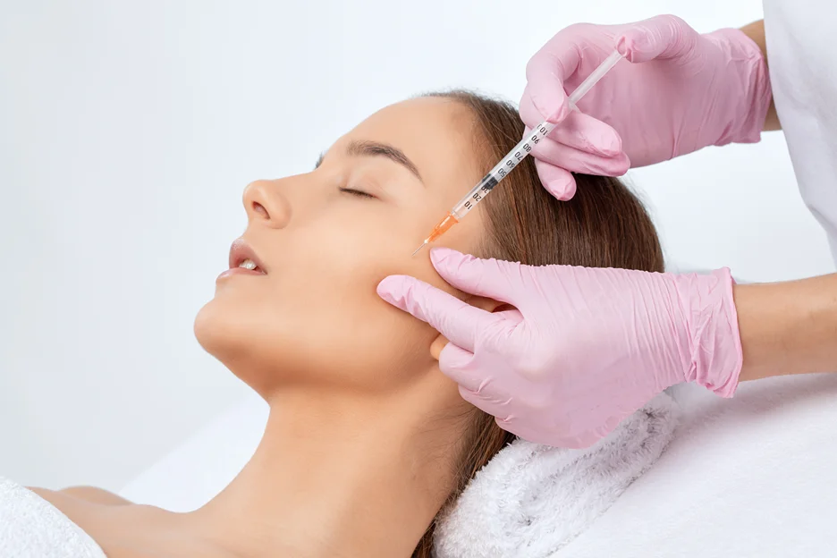 A woman getting cheek filler treatment